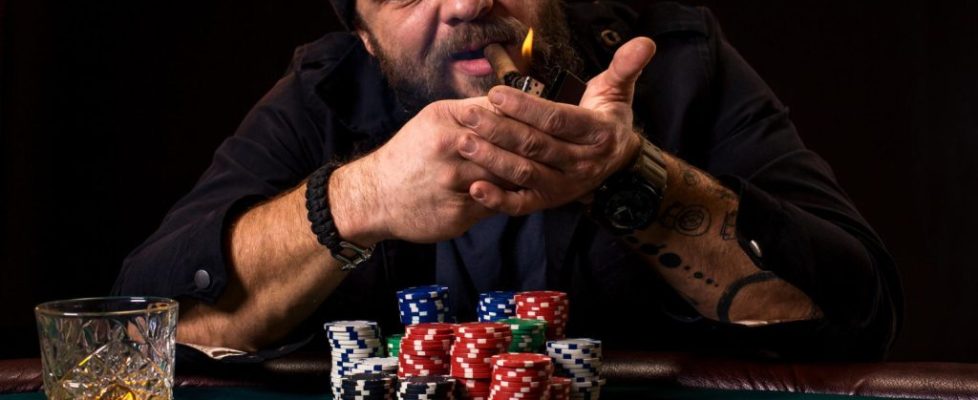 bearded-man-with-cigar-glass-sitting-poker-table-casino-gambling-playing-cards-roulette-green-poker-table-are-cards-chips-money-whole-room-is-smoke-from-cigars