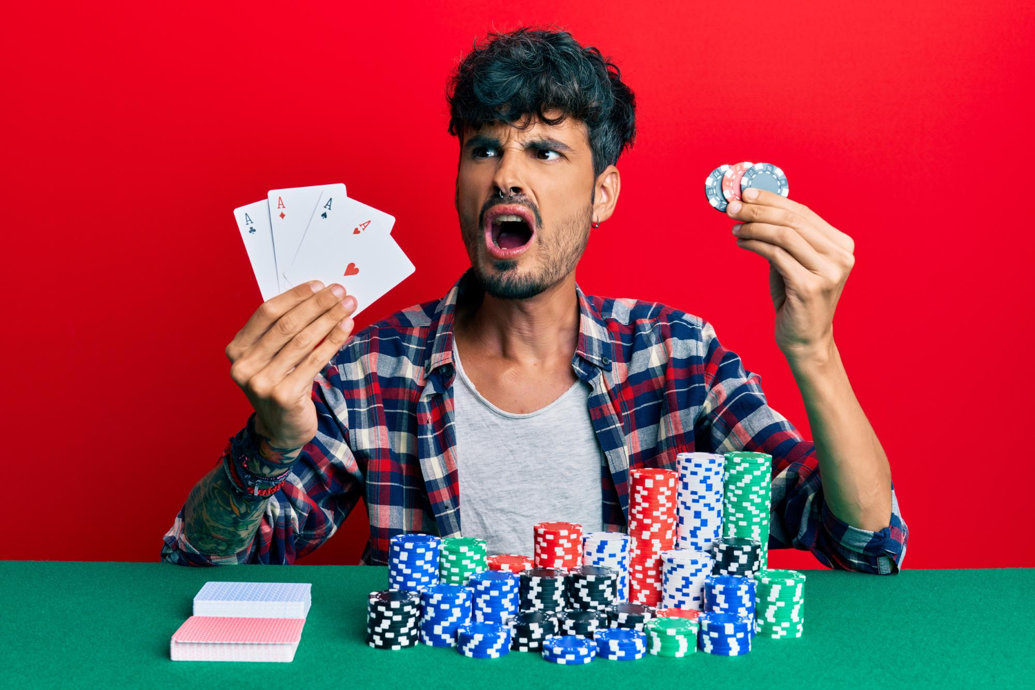 young-hispanic-man-playing-poker-holding-cards-casino-chips-angry-mad-screaming-frustrated-furious-shouting-with-anger-rage-aggressive-concept
