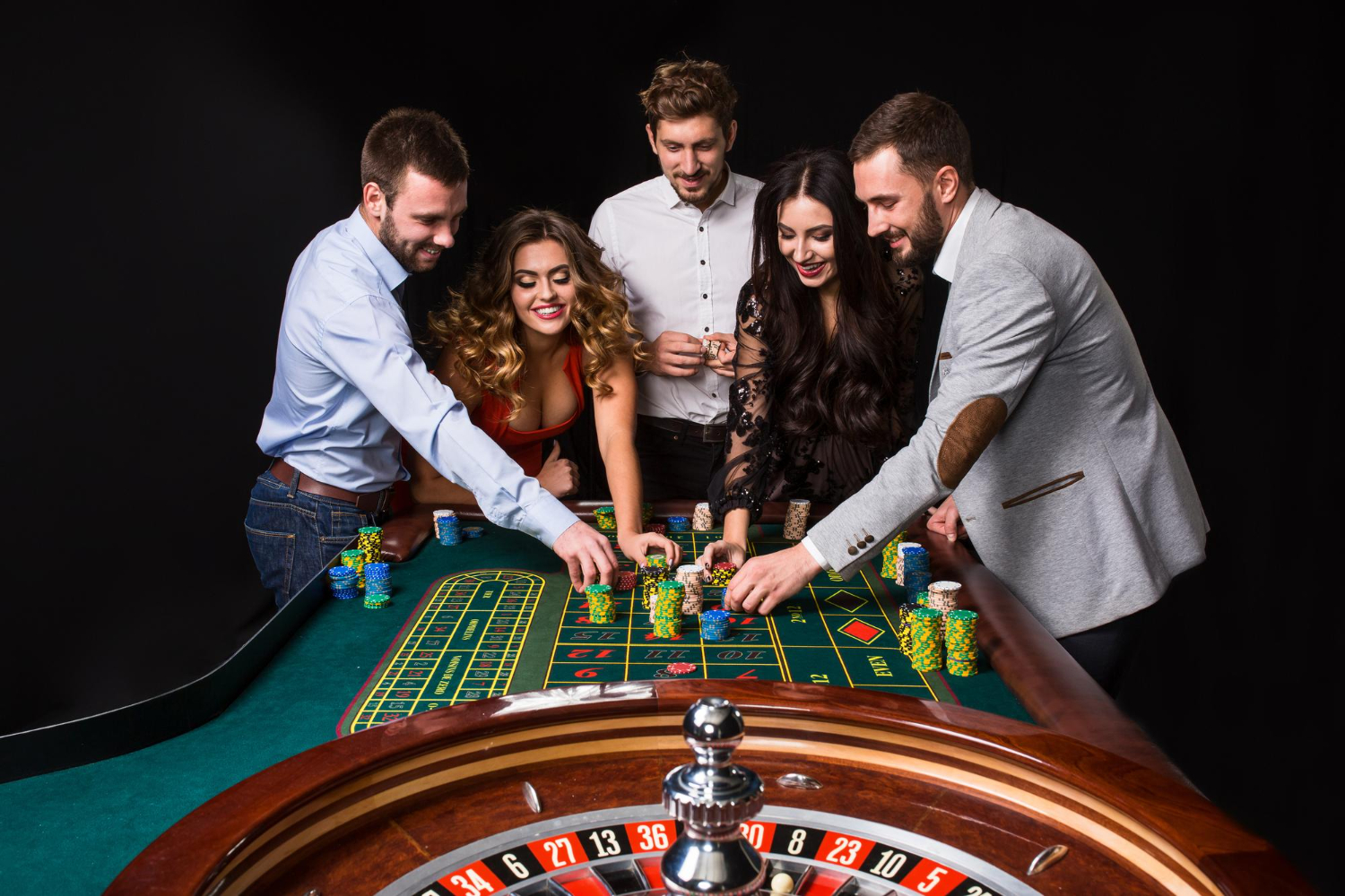 group-young-people-roulette-table-black-background-young-people-are-betting-game